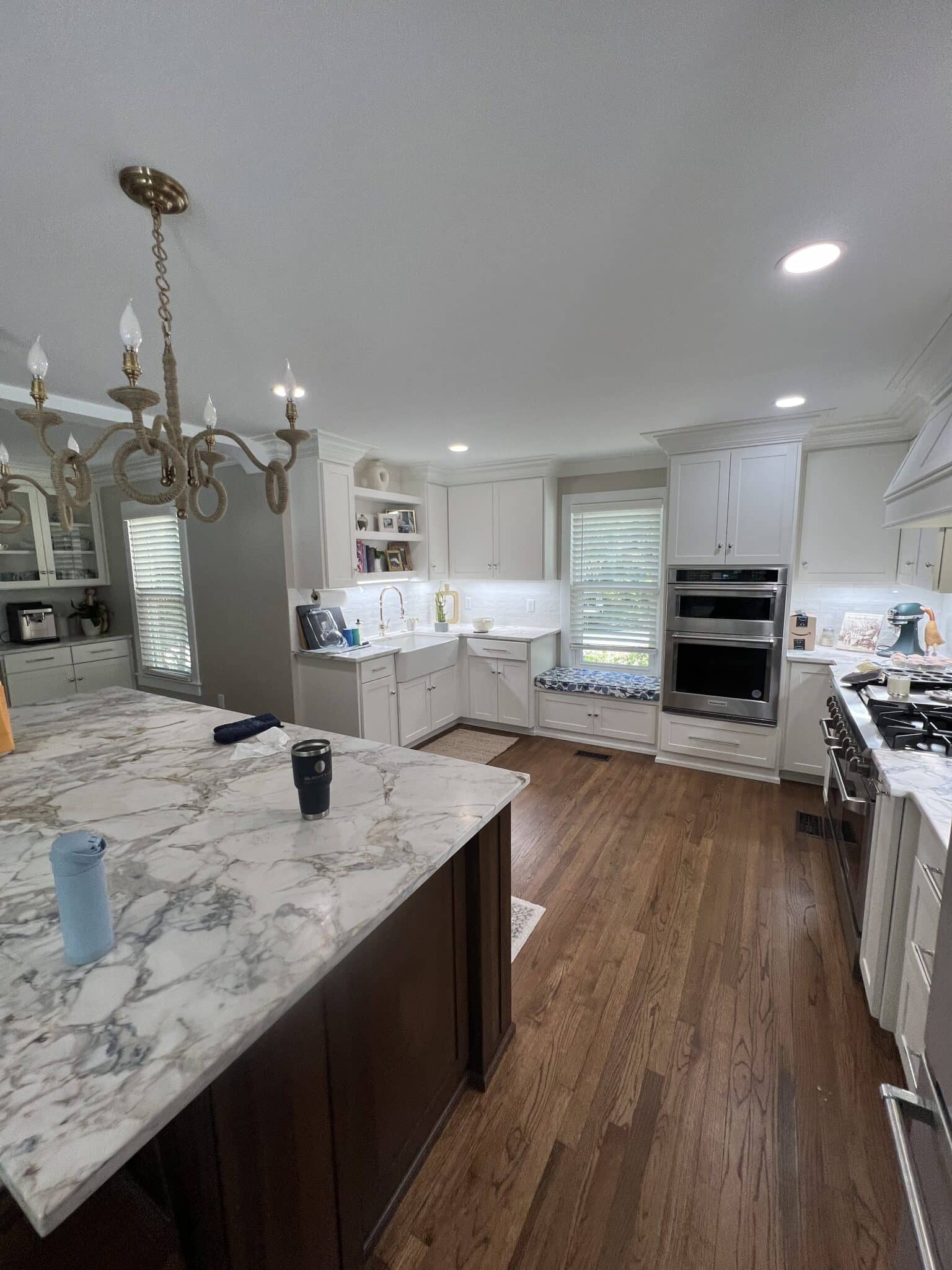 Newly renovated kitchen with can lights and chandelier