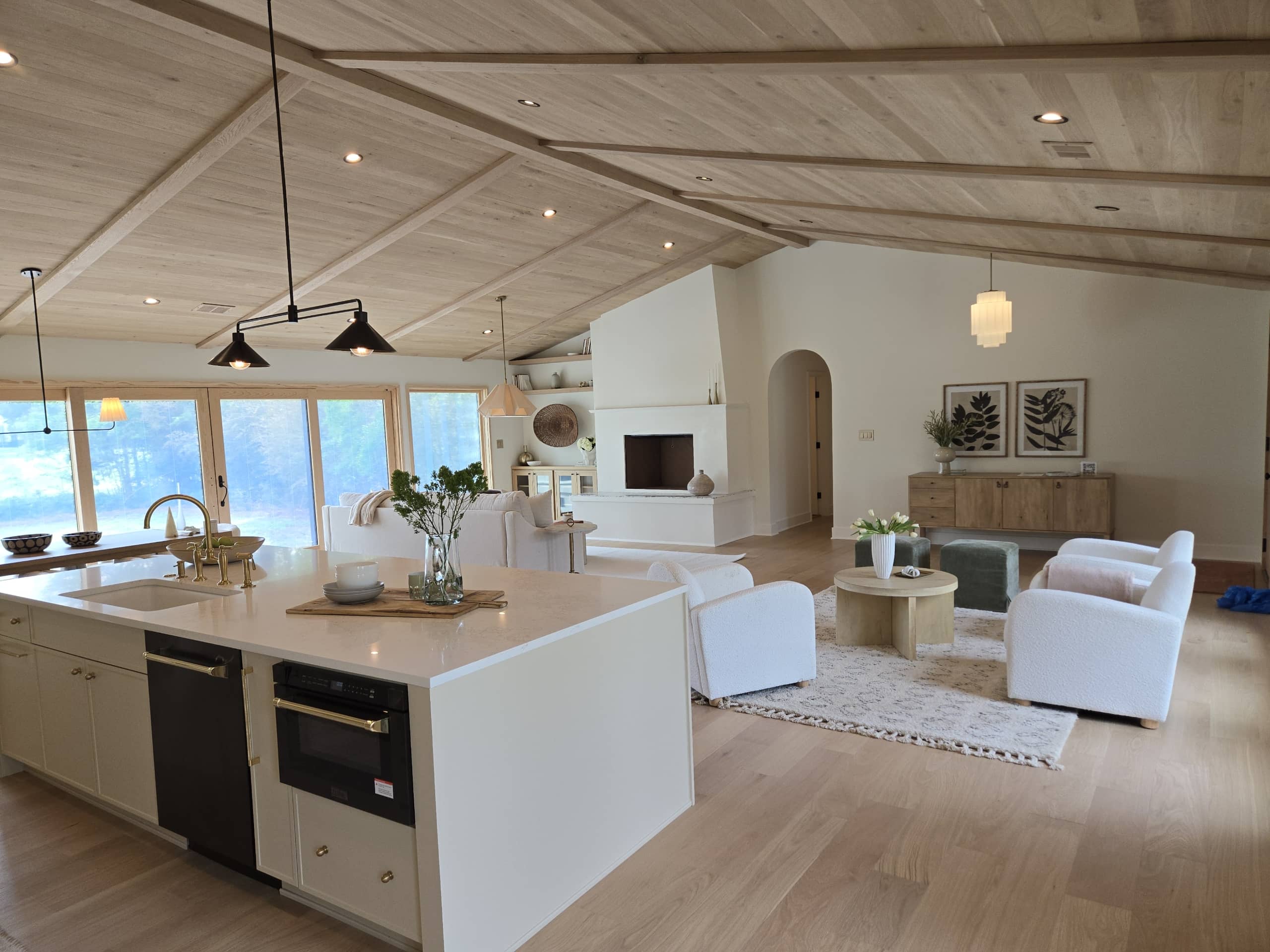 modern living room with can lights and chandelier